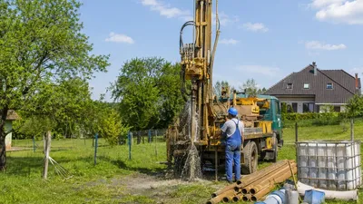 Vŕtacia súprava na pozemku pri vŕtaní studne v dedinskej zástavbe